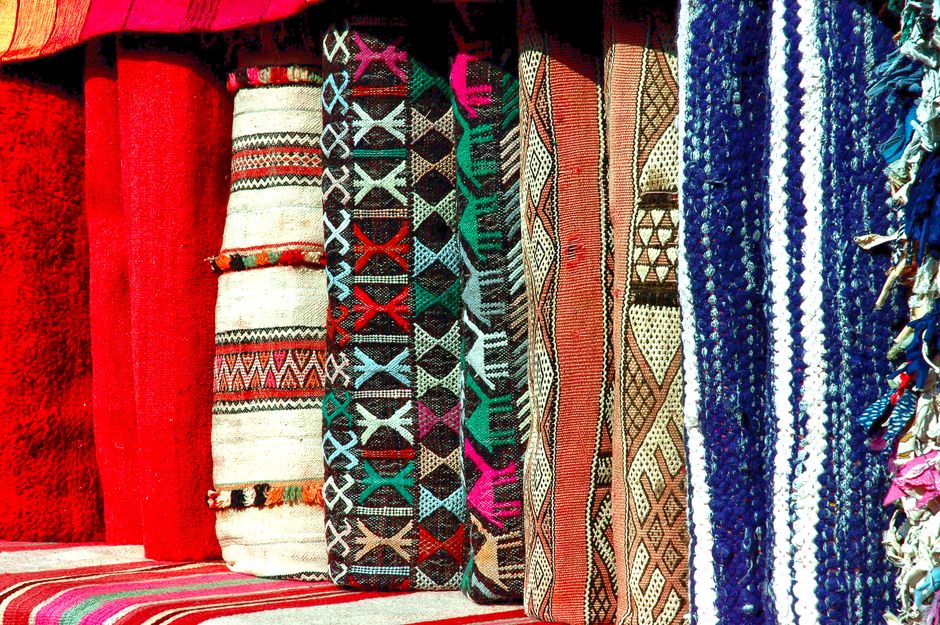 A vibrant collection of traditional woven textiles showcasing intricate patterns.